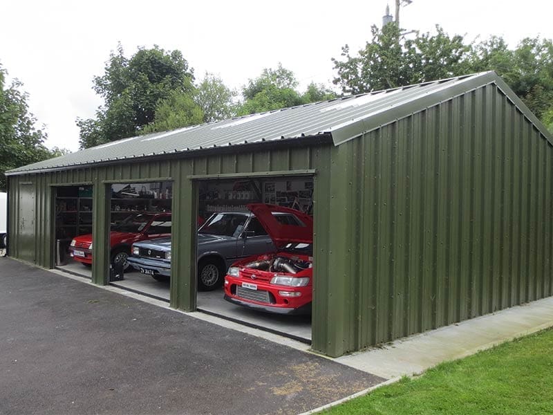 12.2m x 7m Gold Range garage with vertical profile cladding with 3 roller doors