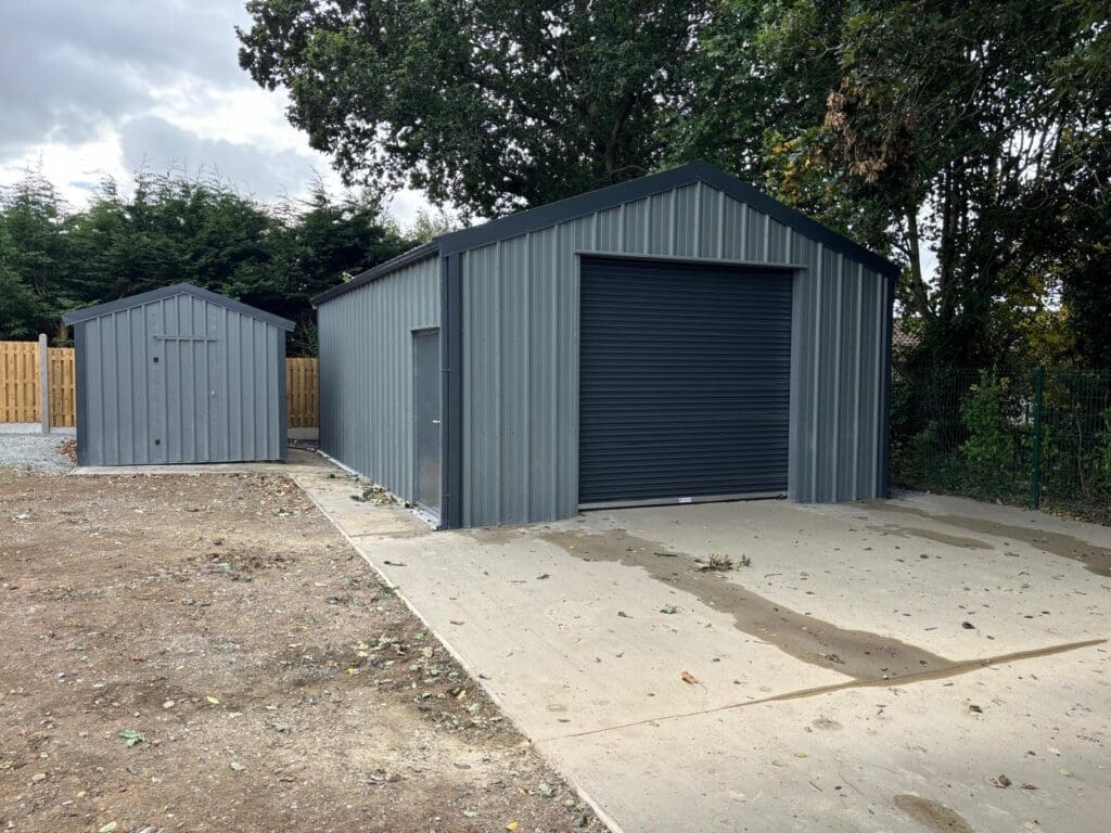Shanette 3.3m x 3m bronze range steel garden shed and 9m x 6m Kingspan steel garage in Anthracite and Merlin
